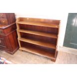 A 1920's mahogany waterfall bookcase on bracket feet