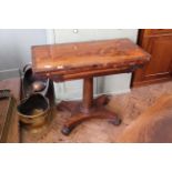 A William IV mahogany card table on platform base with rosewood cross banded top