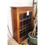 A 1930's glazed oak bookcase with leaded door,