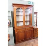 A late 19th Century mahogany cupboard bookcase with two doors and fielded panelled doors below