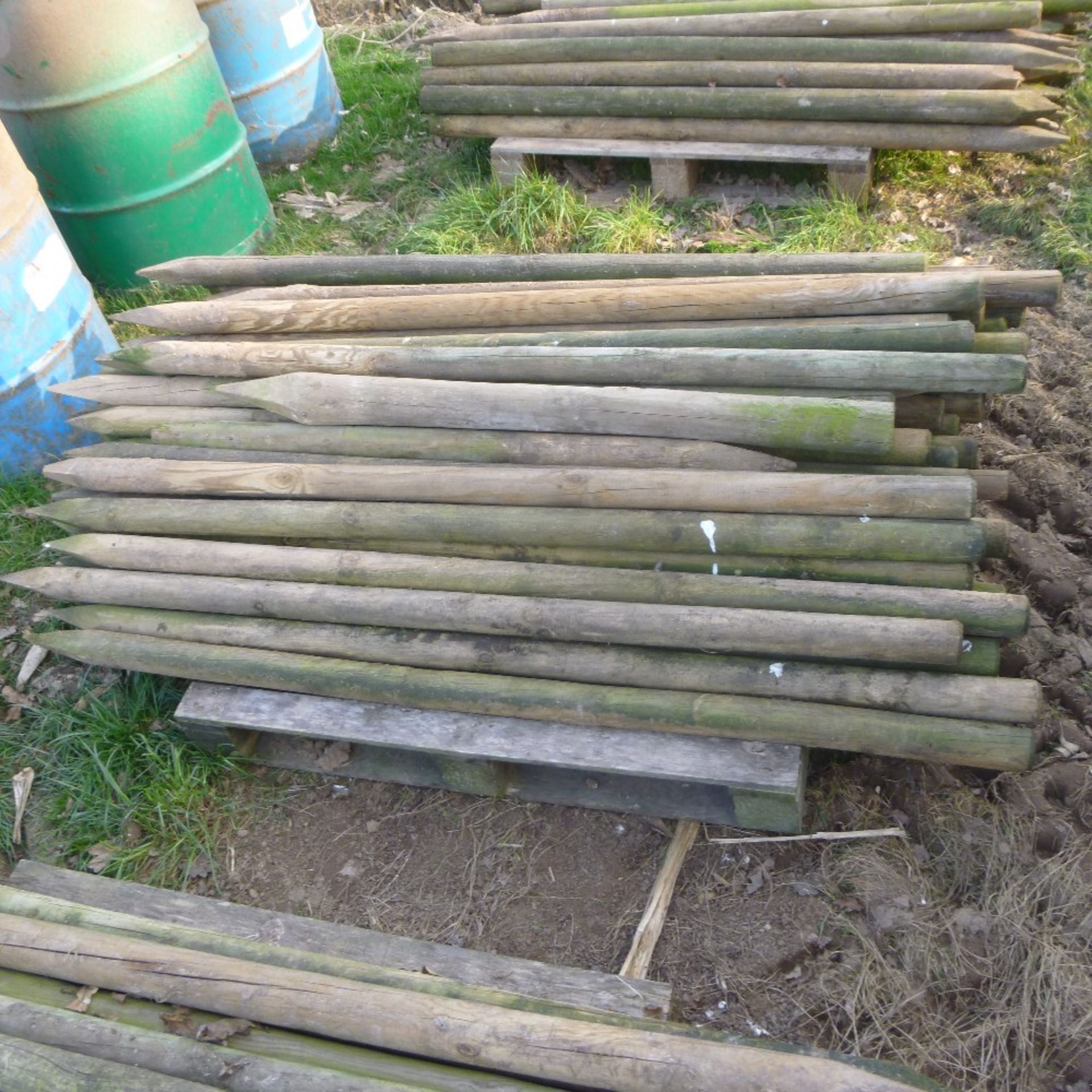 Pallet of used round fencing stakes, approx.