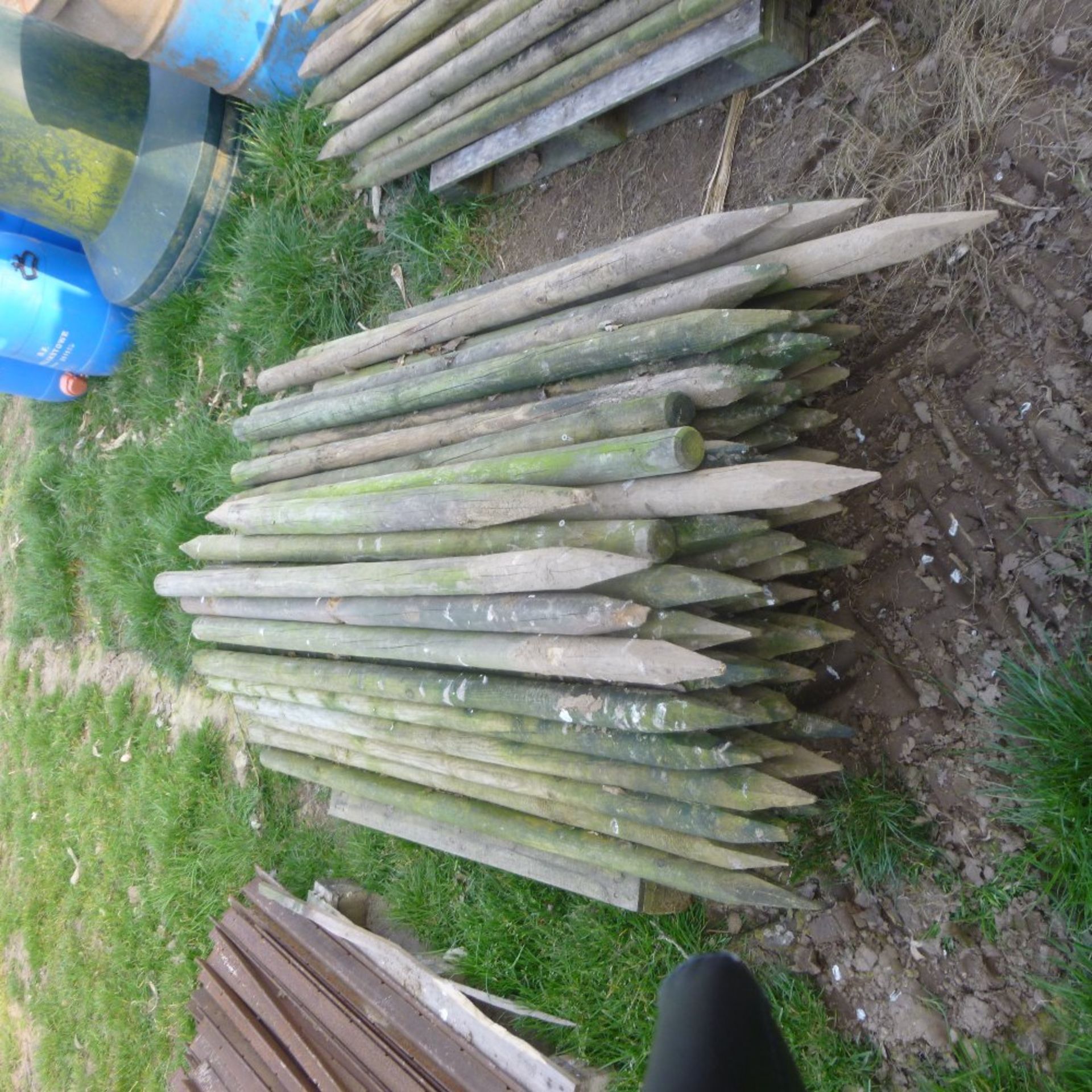 Pallet of used round fencing stakes, approx.