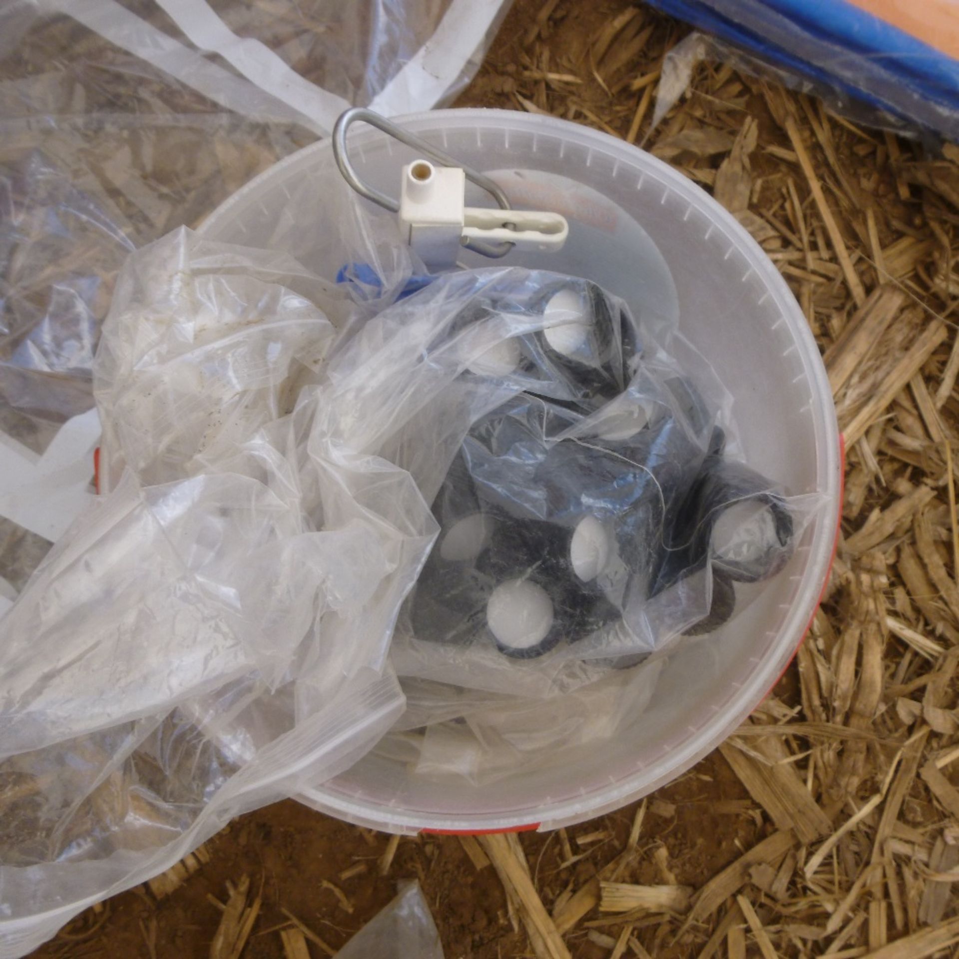 Bucket of rainbow valve spares.