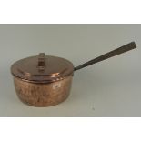 A large 19th Century seamed copper saucepan with iron handle and lid having copper handle,