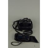 A Minolta 110 Zoom SLR camera plus an Olympus MJU I 35mm camera
