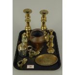 A pair of antique brass candlesticks with ejectors and a seamed copper small jug etc