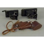Two vintage Kodak bellow cameras plus a 'Orilux' London lamp in case