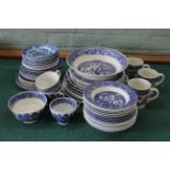 A box of blue and white dinner wares, mainly Willow pattern,