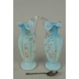 A pair of late 19th Century Bohemian pale blue opaline glass rose water ewers with enamel