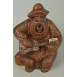 A vintage pottery biscuit barrel modelled as a Big Al Country Bear Jamboree playing a guitar,