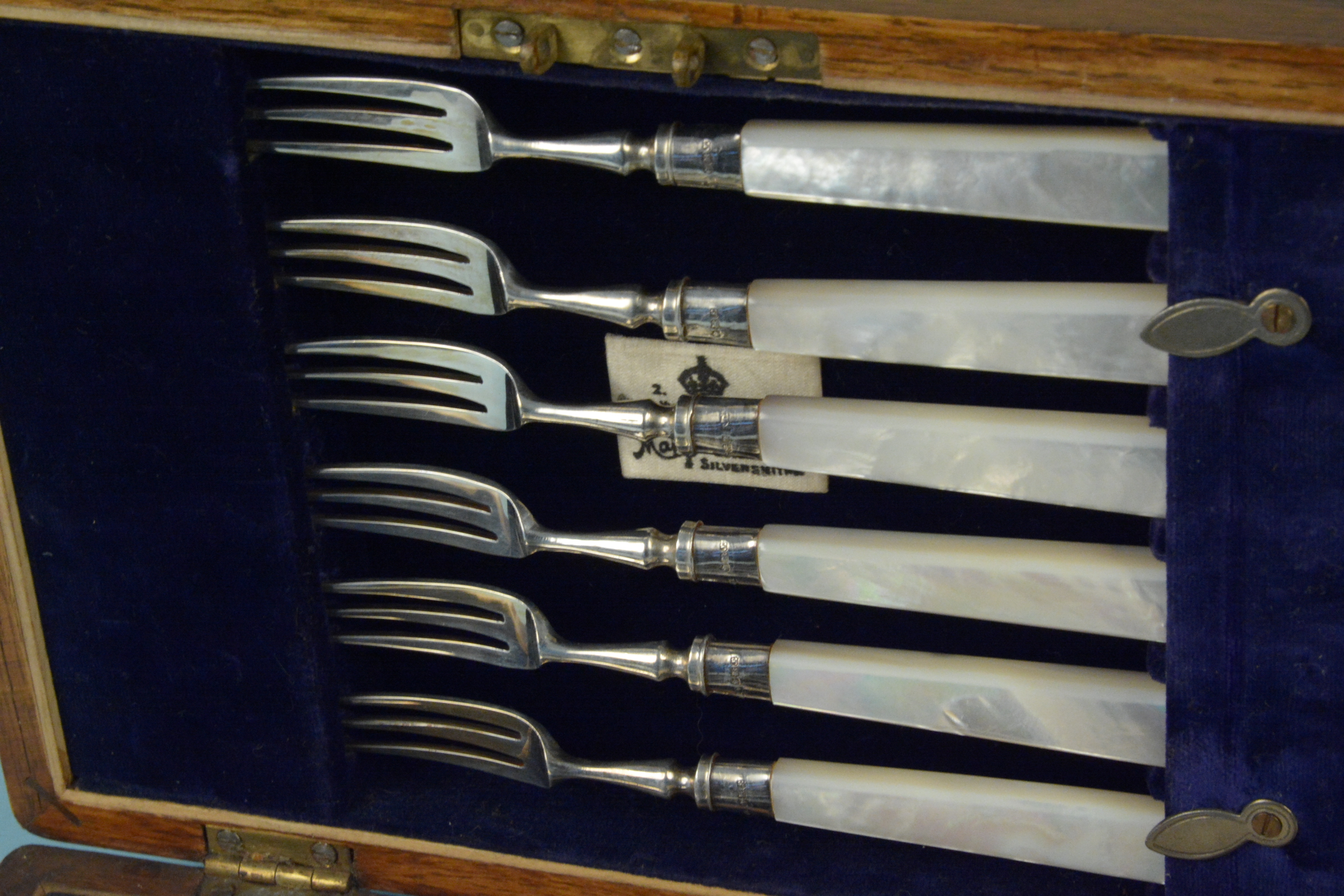 A cased set of six silver dessert knives and forks with mother of pearl handles (one knife is as - Image 3 of 3