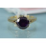 A 9ct gold amethyst ring, the round stone in eight claw setting (one claw bent), size O 1/2,