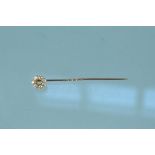 A yellow metal diamond cluster stick pin