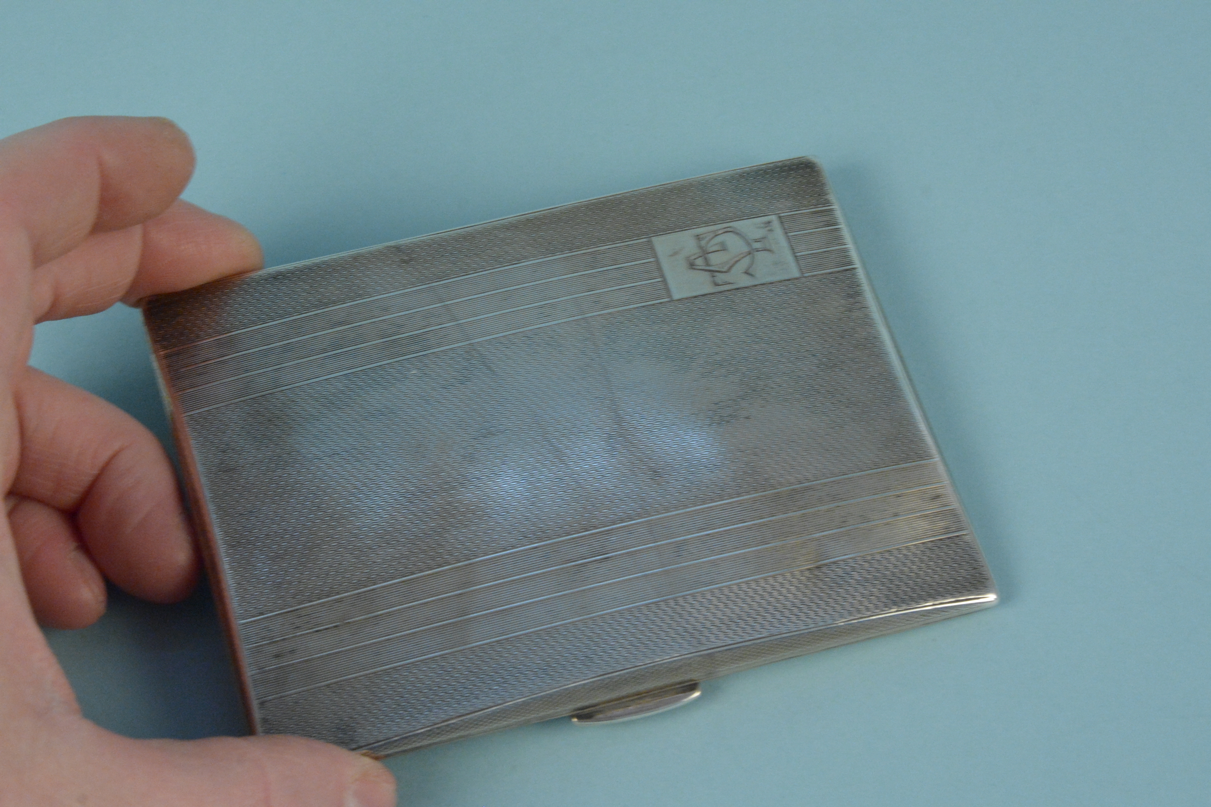 A silver cigarette case with engine turned detail and engraved monogram, - Image 2 of 3