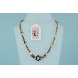 An unusual 9ct gold garnet set necklace,