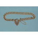 A 9ct gold curb link bracelet with heart shaped padlock clasp,