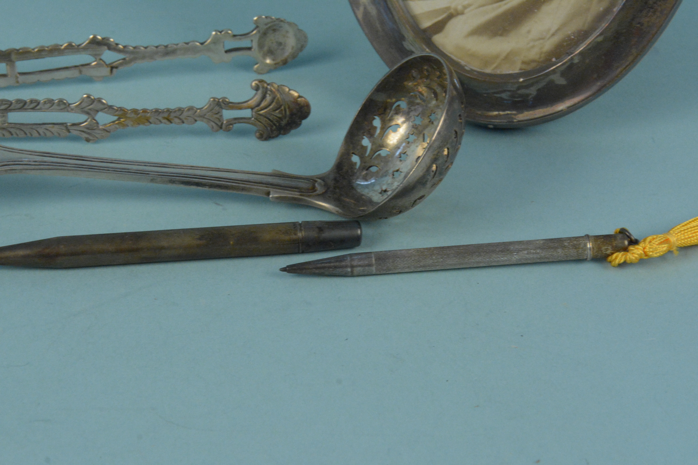 A Victorian silver sifting spoon, a pair of Georgian silver tongs (as found), - Image 3 of 3