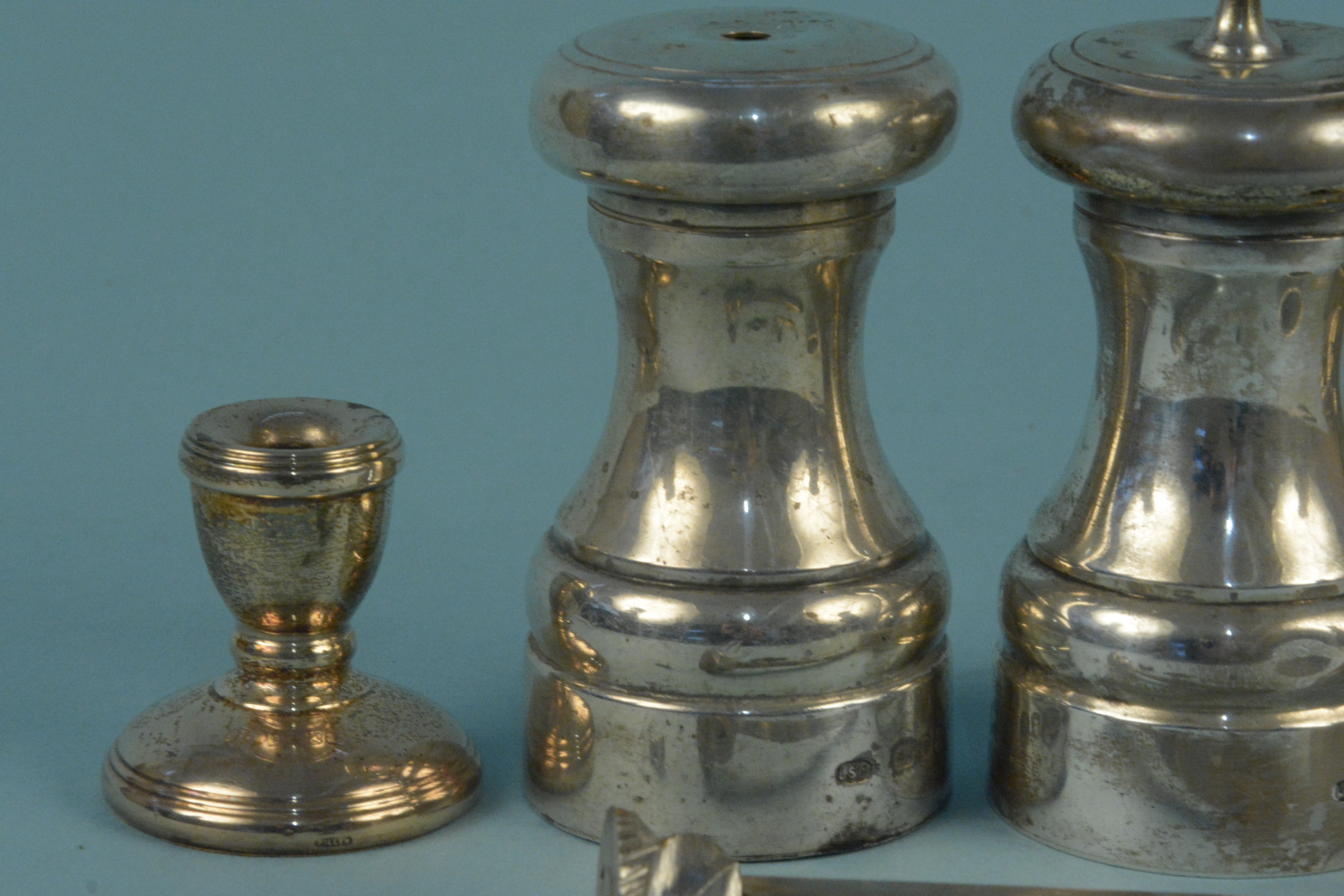 A silver pepper mill (as found), a silver salt of mill form and two miniature silver candlesticks - Image 2 of 3