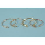 Four 9ct gold torque bangles, all with wire,