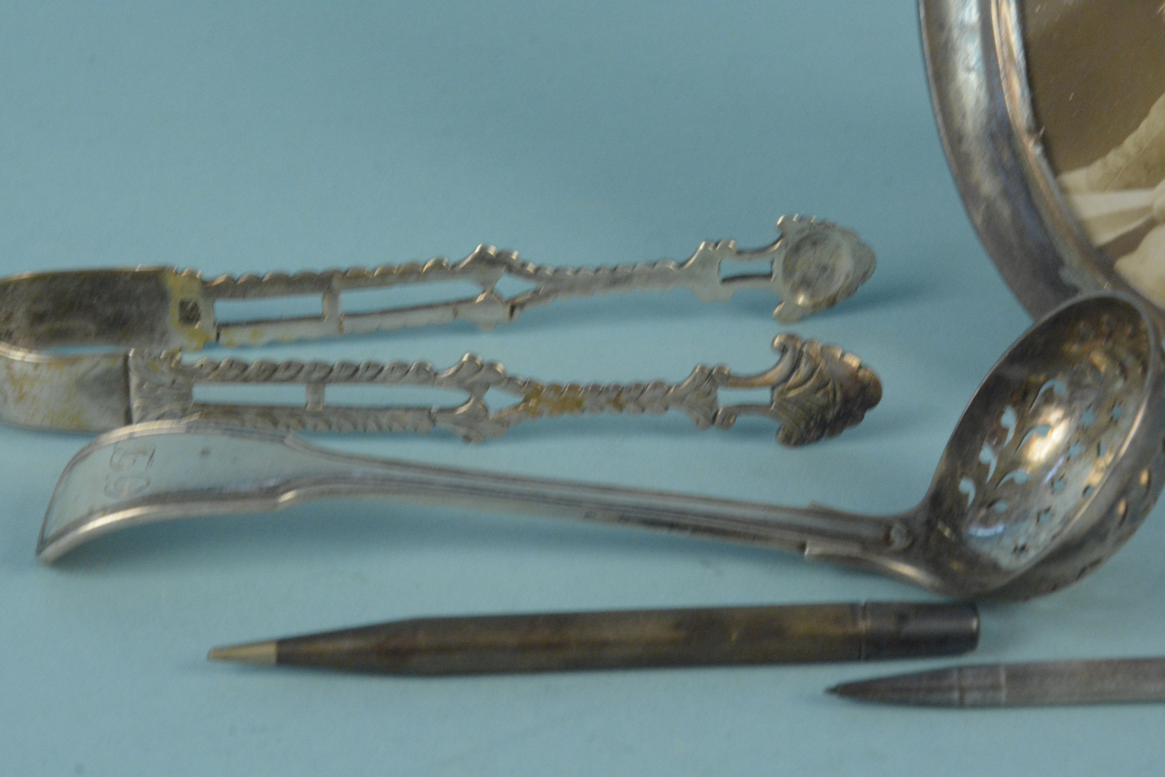 A Victorian silver sifting spoon, a pair of Georgian silver tongs (as found), - Image 2 of 3