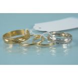 Four 9ct gold wedding bands, one in white gold with textured detail,
