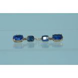 A pair of antique blue stone set drop earrings set in yellow metal
