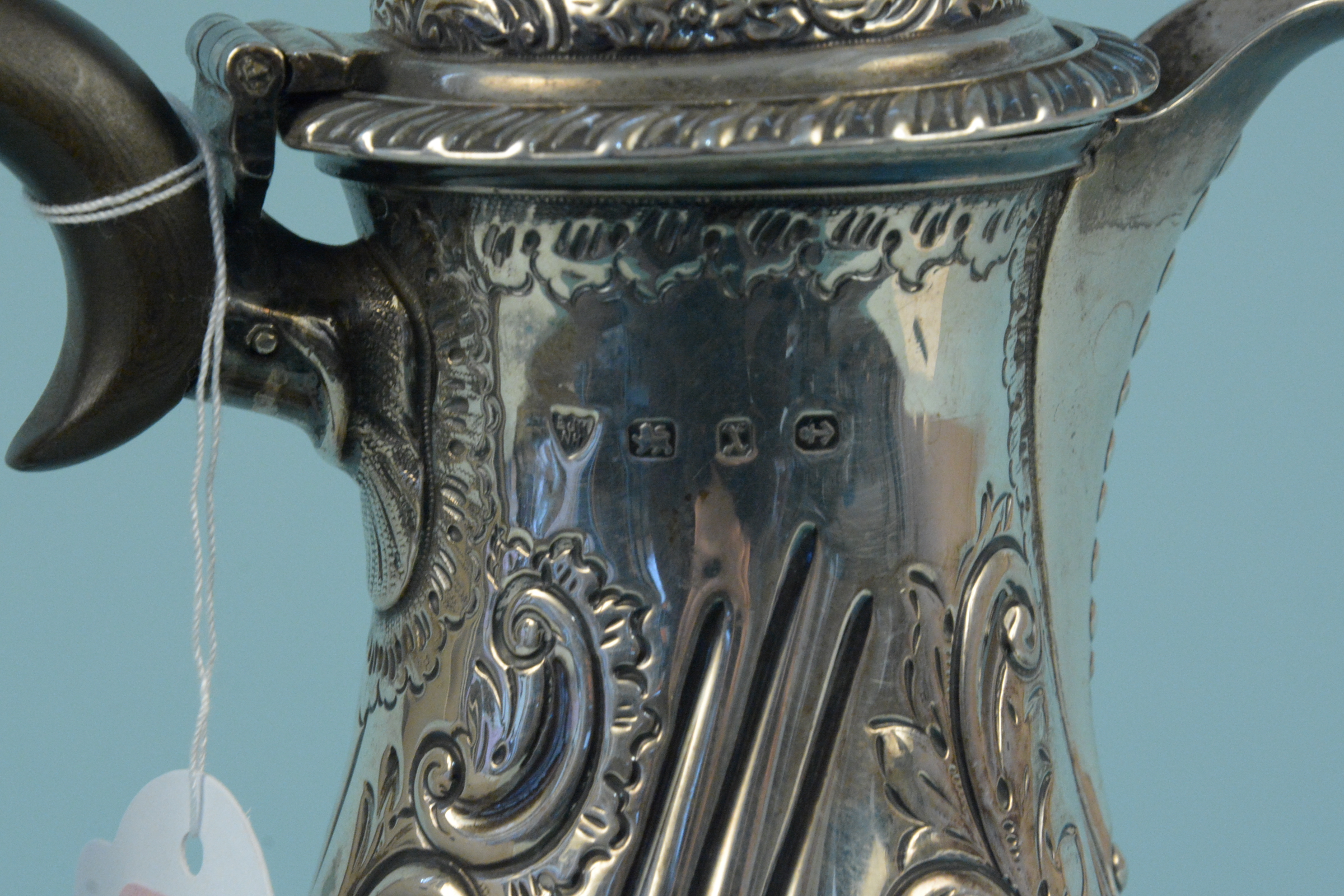 A Victorian silver coffee pot with embossed floral decoration on flared base, engraved with crest, - Image 3 of 3