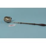 A Georgian silver toddy ladle decorated with floral detail and engraved initials,