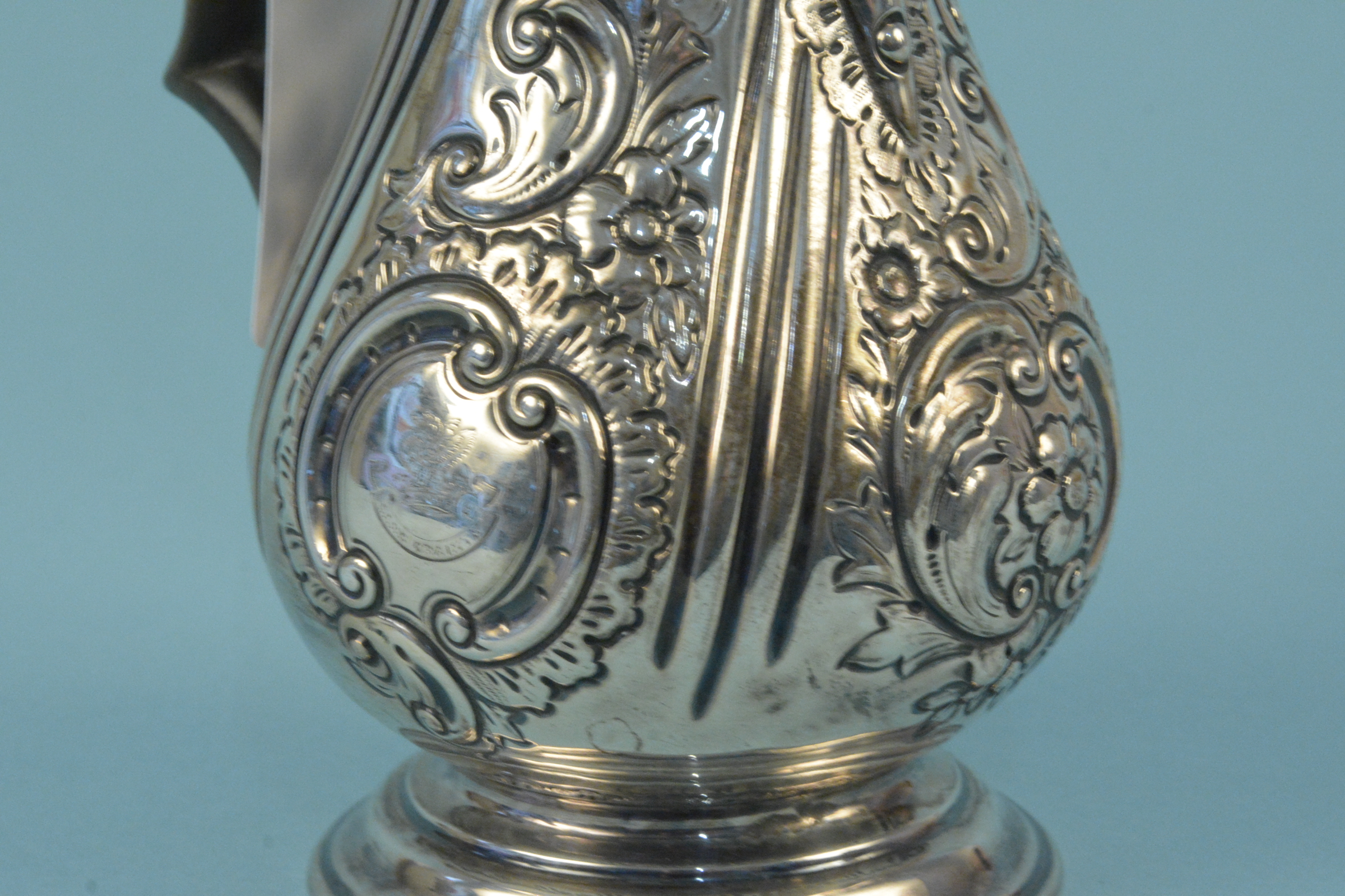 A Victorian silver coffee pot with embossed floral decoration on flared base, engraved with crest, - Image 2 of 3