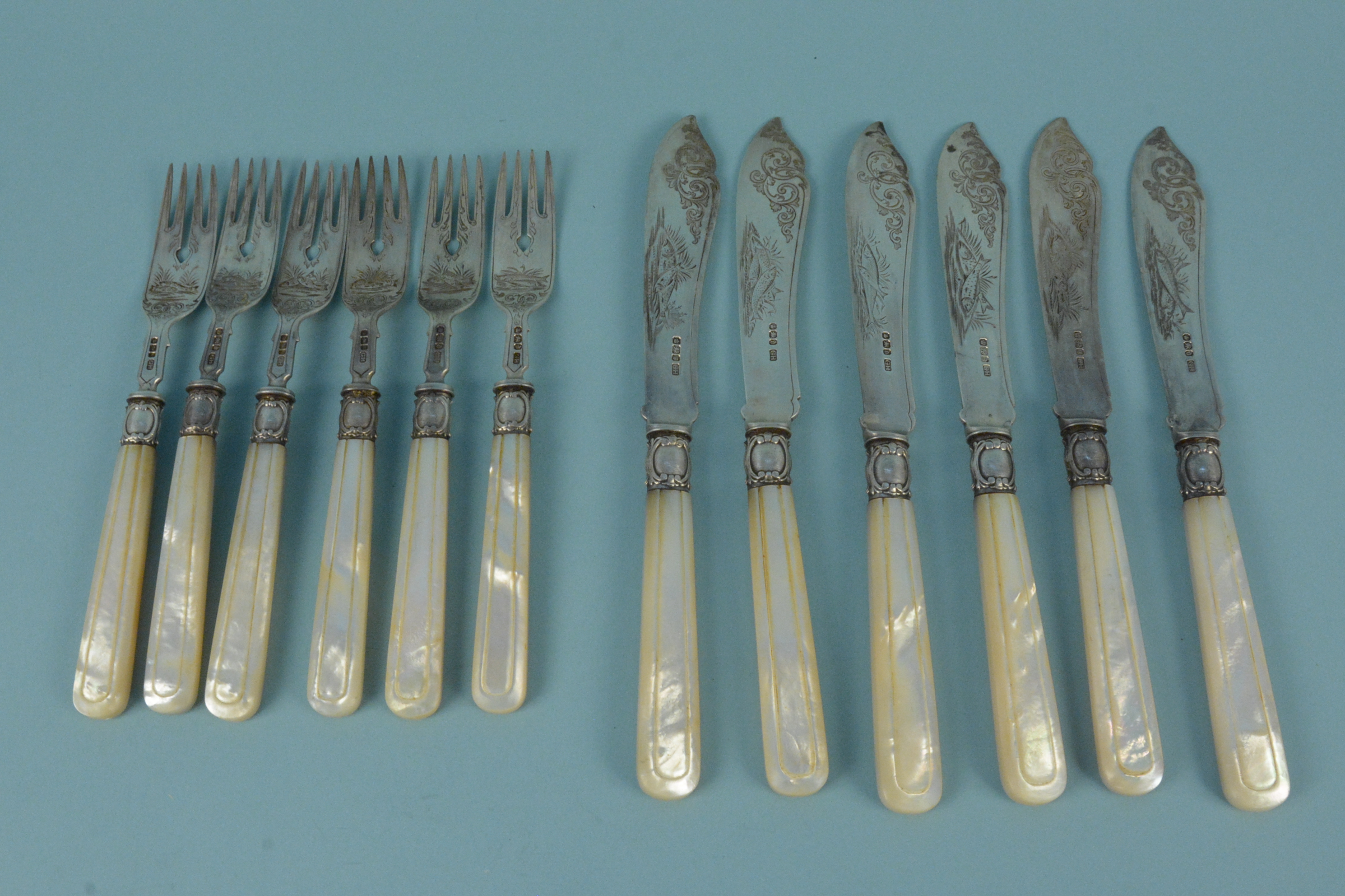 A set of six silver mother of pearl handled fish knives and forks,