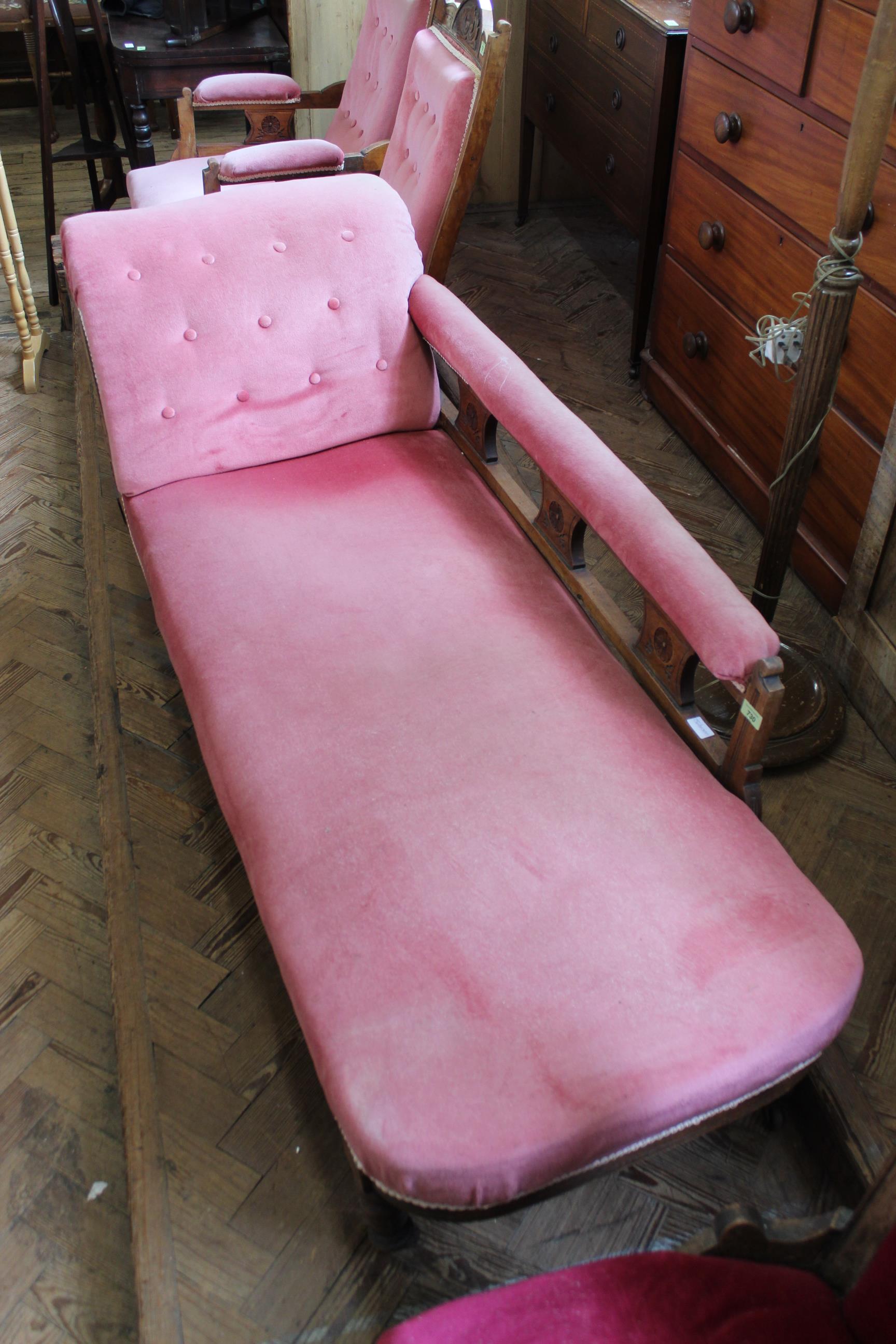 A walnut framed and velvet upholstered chaise longue