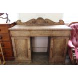 A William IV faded mahogany pedestal sideboard with carved top piece