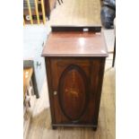 An Edwardian mahogany cupboard with inlaid panel