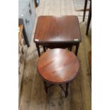 A 20th Century nest of three mahogany drop leaf tables under a square table