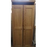 A late 19th Century pine two door cupboard with shelved interior, approx.