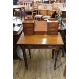 A late Victorian American walnut writing table with six drawers and fitted stationary box