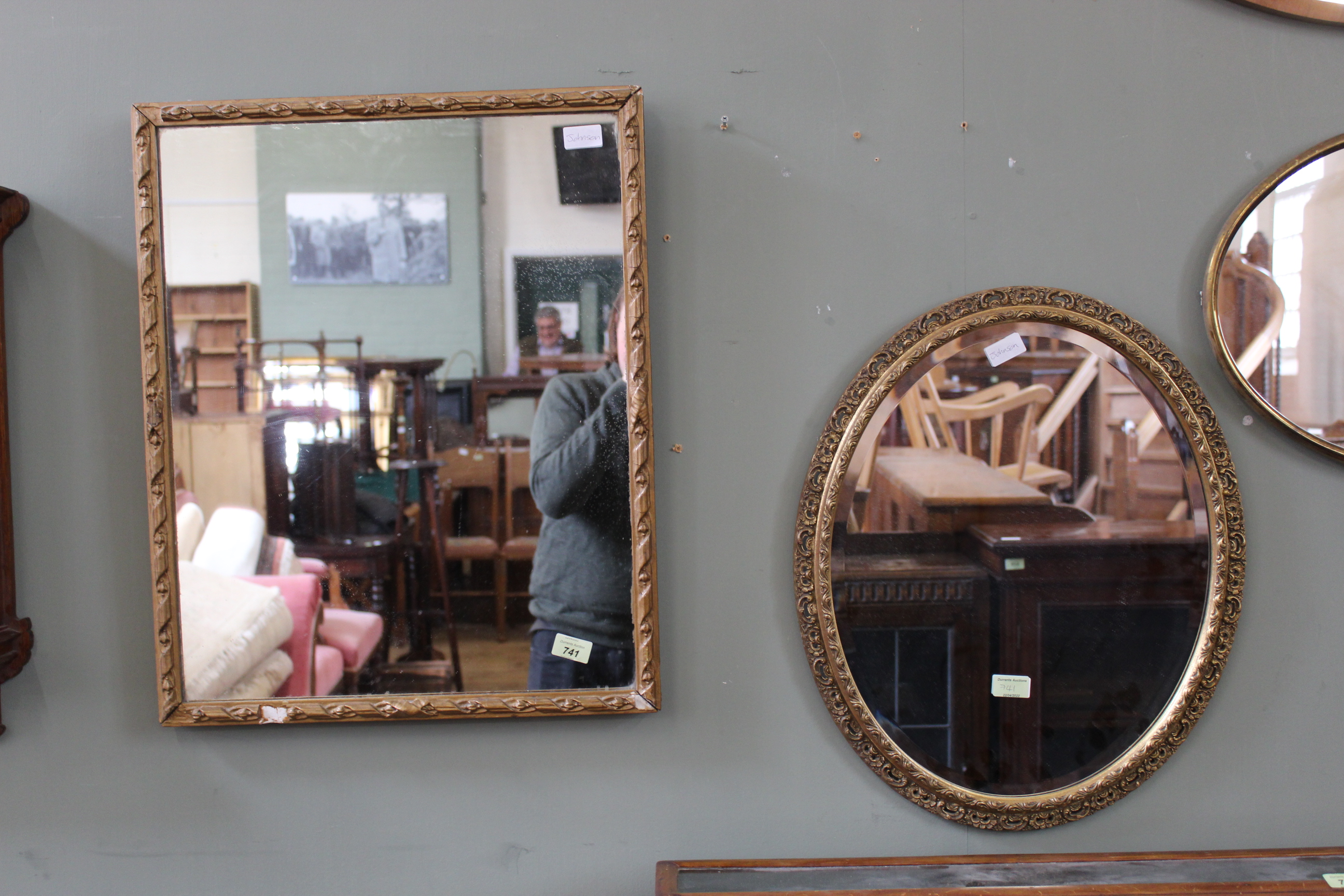 A 19th Century gilt wall mirror and a 20th Century oval gilt wall mirror