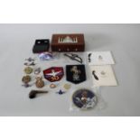 A mixed lot including various insignia with an inlaid box