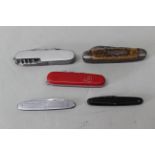 Five pocket knives including a vintage U.S. Navy example