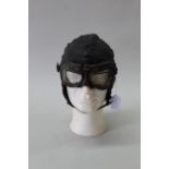 A vintage leather flying helmet by Burberrys with a pair of leather mounted goggles