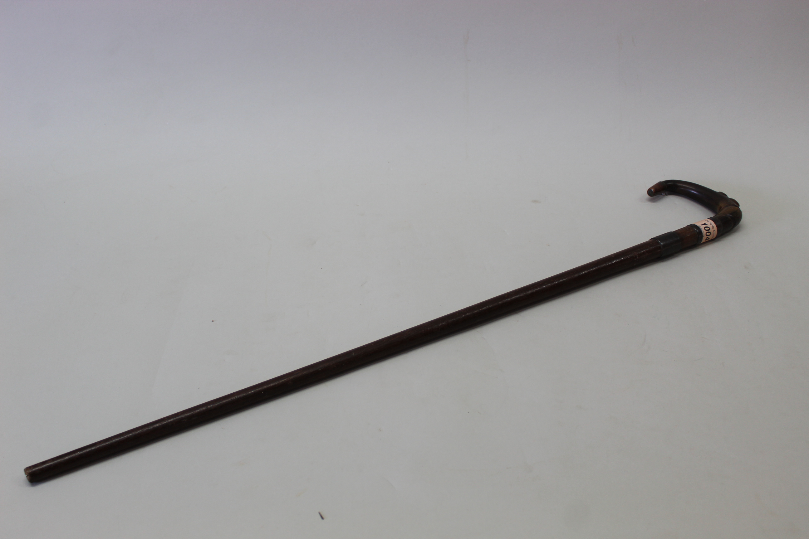 A walking stick with copper mounted 'horn' handle,