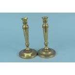 A pair of late 18th Century French seamed brass candlesticks with engine milled decoration,