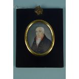 An early 19th Century portrait miniature of a gentleman in the original lacquered papier mache