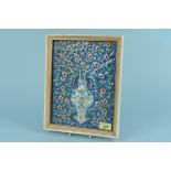 A framed Islamic ceramic tile of a stylised vase with flowers,