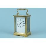 A late 19th Century brass carriage clock with enamel dial and bevelled glass throughout