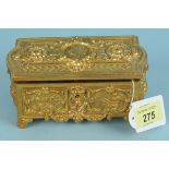 A vintage heavily gilded lidded jewellery box with red velvet interior,