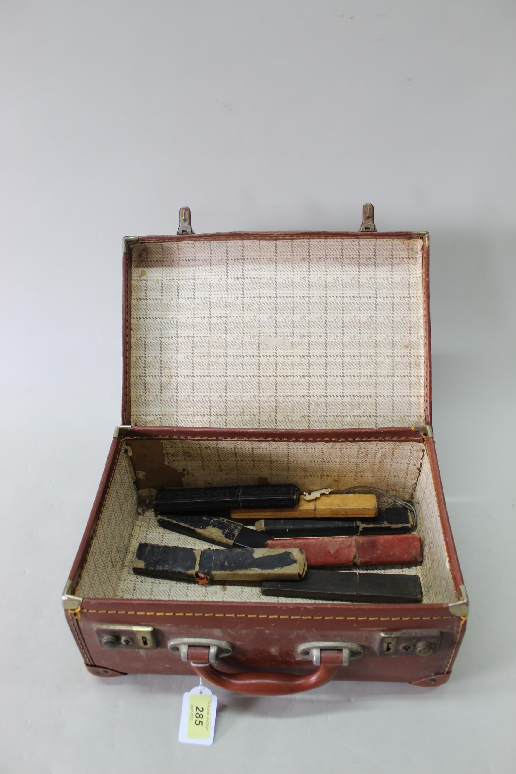 Seven vintage cased cut throat razors (signs of age and wear to boxes) plus a small brown leather