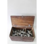 A box containing a large selection of vintage metal moulds for lead toys