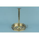 A large Arts and Crafts brass chamberstick with wide octagonal shaped base having pierced gallery,