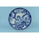 A large late 19th Century Japanese blue and white charger decorated with two dragons and flowers,